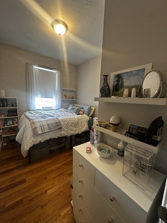 199 Athens Street, Unit 3 Boston, MA 02127 - Photo 13 of 18 a bedroom with a bed and wooden floor