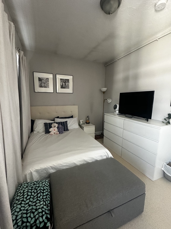 199 Athens Street, Unit 3 Boston, MA 02127 - Photo 15 of 18 a bedroom with a bed and a view of kitchen