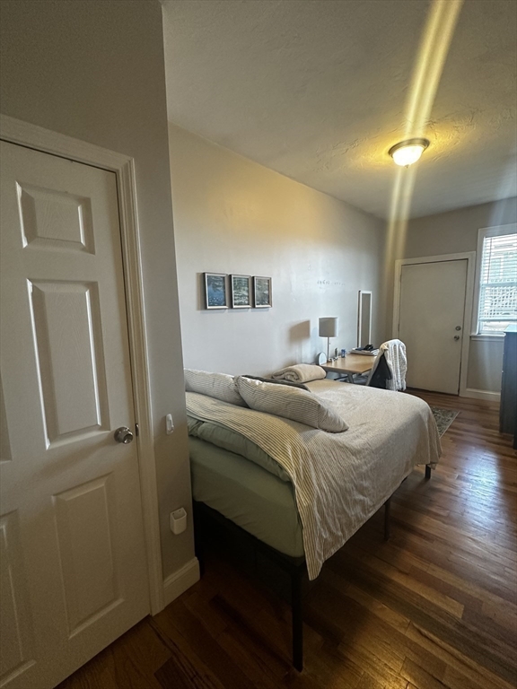 199 Athens Street, Unit 3 Boston, MA 02127 - Photo 8 of 18 a bedroom with a bed and wooden floor