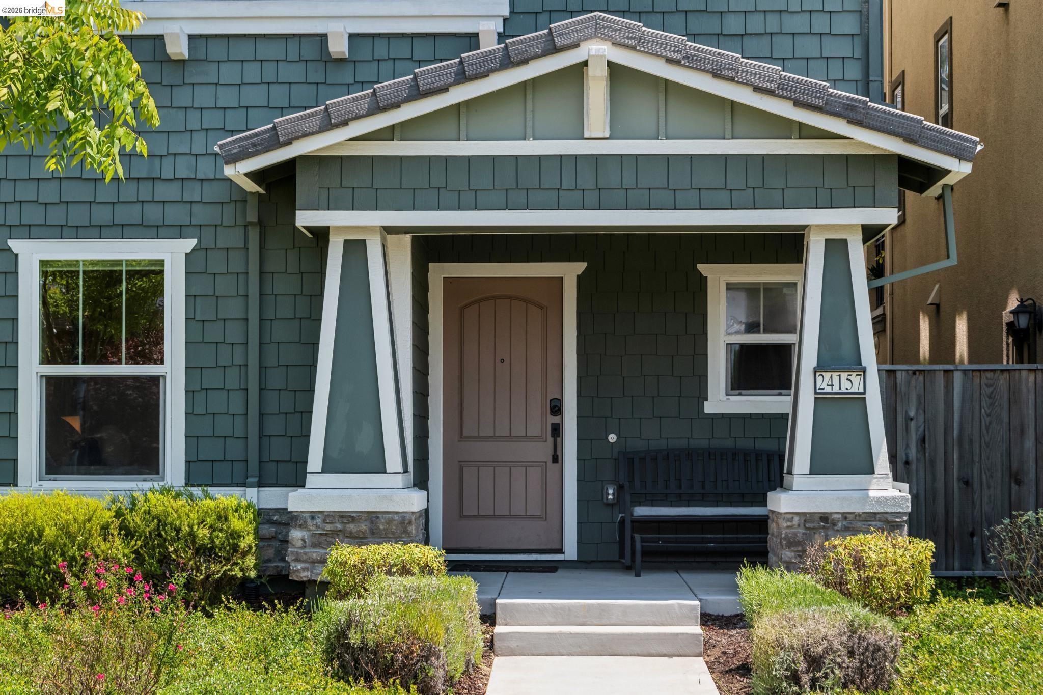 24157 Amaranth Loop Hayward, CA 94541 - Photo 4 of 63 Welcoming entry with a covered porch, wood-paneled door, and shaker-style siding