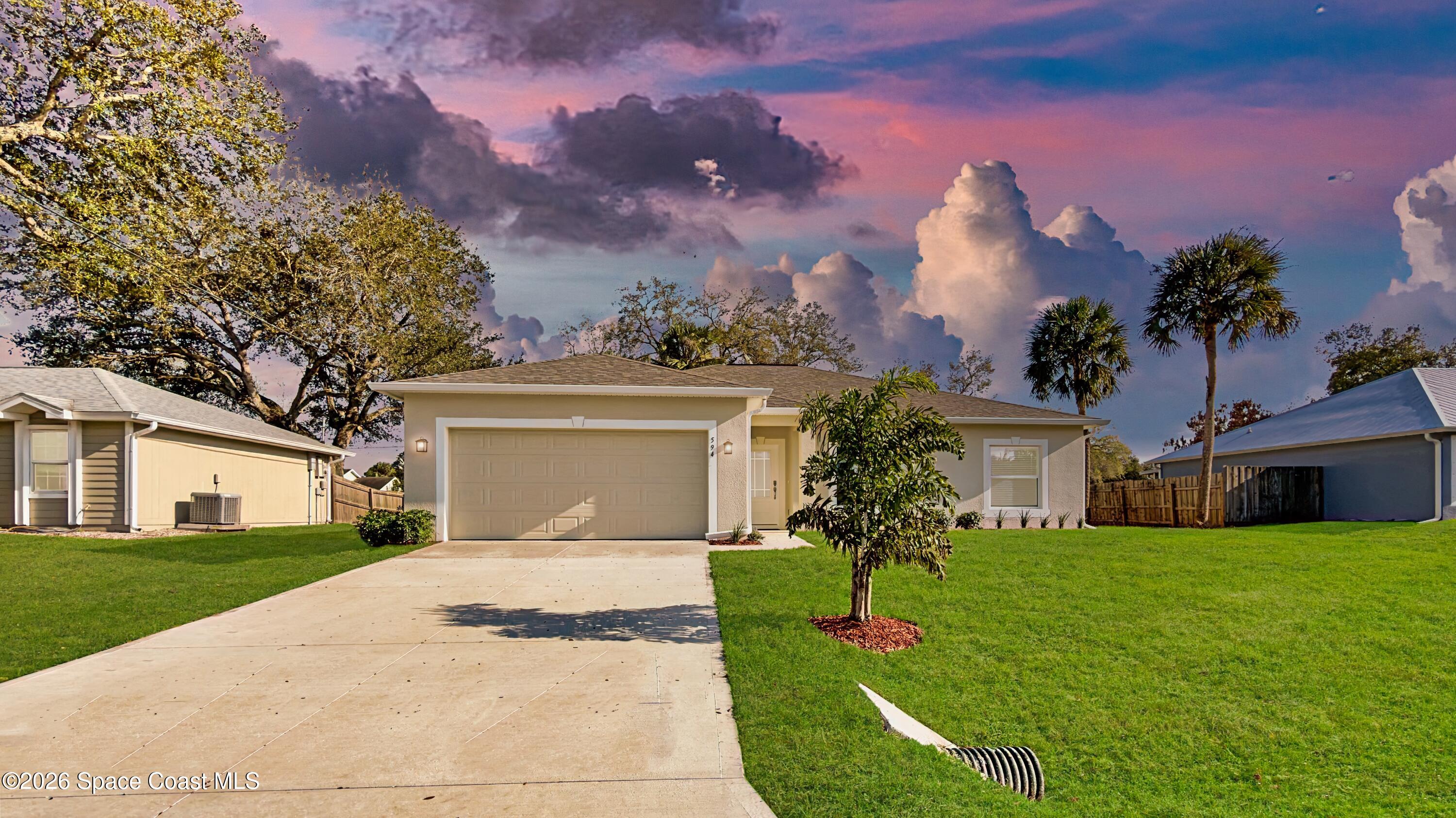 594 Bayharbor Terrace Sebastian, FL 32958 - Photo 1 of 34 a front view of a house with a garden and yard