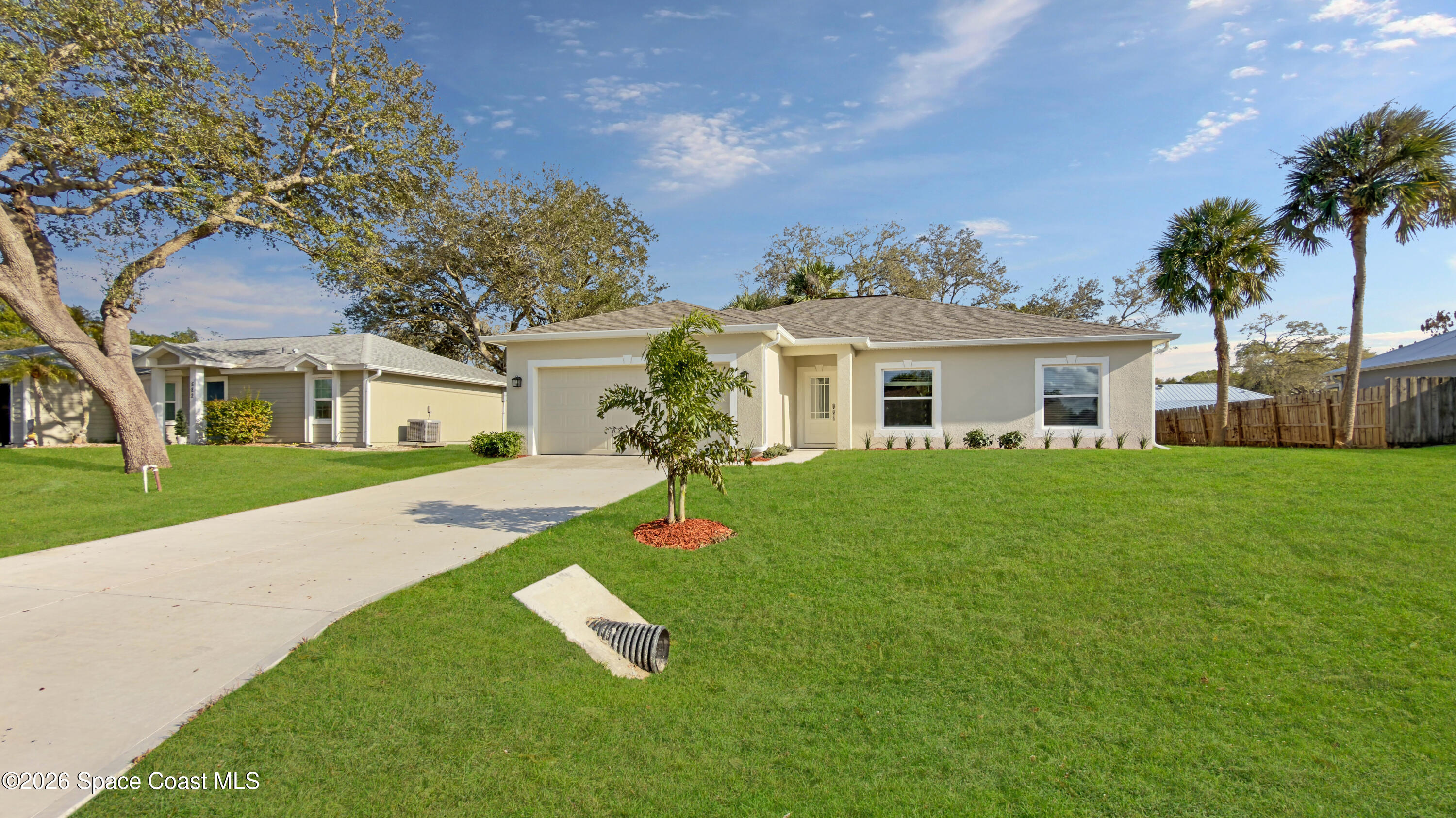 594 Bayharbor Terrace Sebastian, FL 32958 - Photo 2 of 34 a front view of a house with a yard and garage
