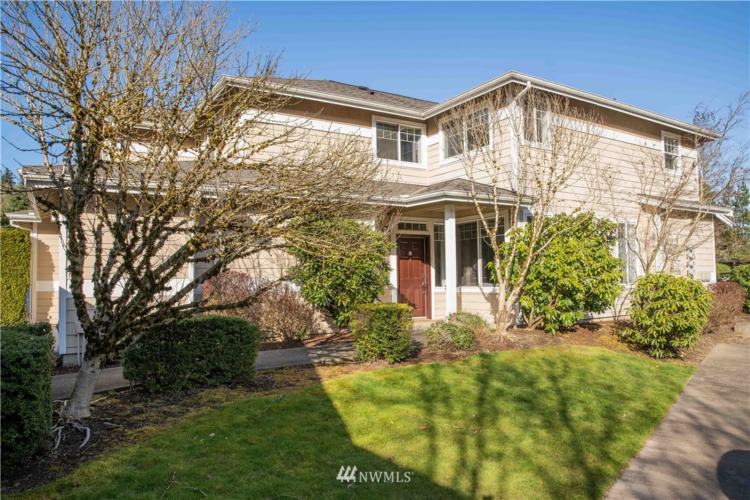 15150 140th Way Southeast, Unit G104 Renton, WA 98058 - Photo 1 of 24 a front view of a house with a yard