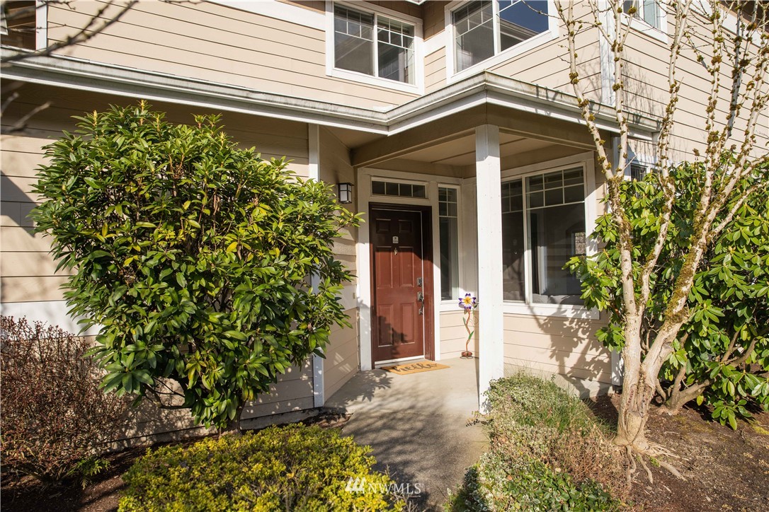 15150 140th Way Southeast, Unit G104 Renton, WA 98058 - Photo 2 of 24 a front view of a house with a yard