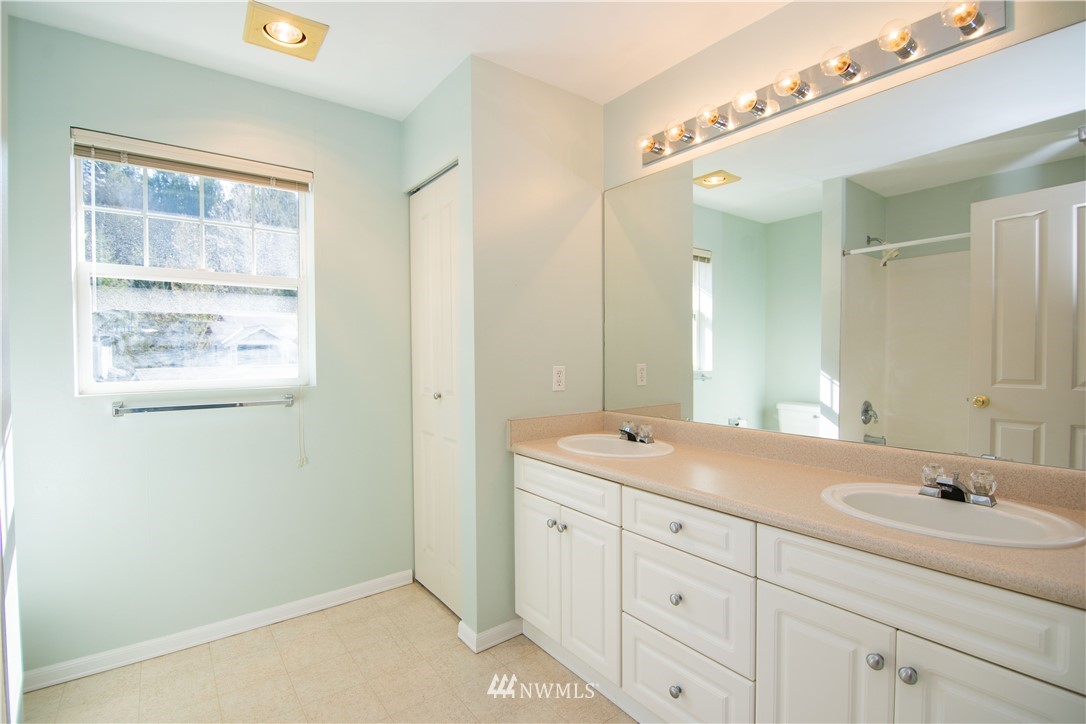 15150 140th Way Southeast, Unit G104 Renton, WA 98058 - Photo 12 of 24 a bathroom with a sink double vanity and a mirror