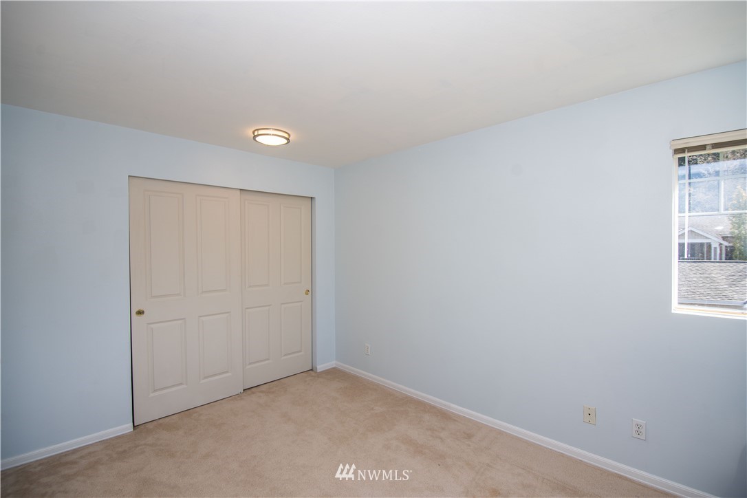 15150 140th Way Southeast, Unit G104 Renton, WA 98058 - Photo 14 of 24 an empty room with windows and closet