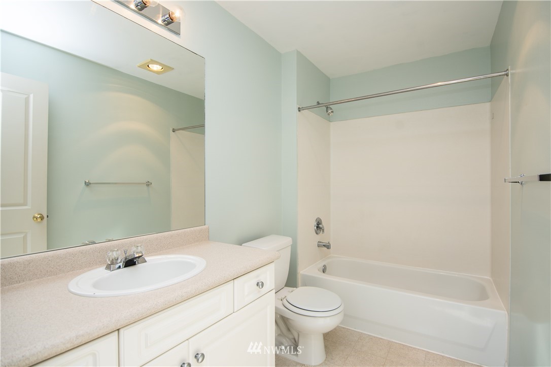 15150 140th Way Southeast, Unit G104 Renton, WA 98058 - Photo 16 of 24 a bathroom with a bathtub shower sink vanity and toilet