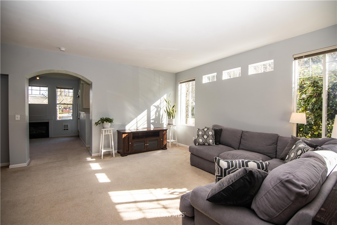 15150 140th Way Southeast, Unit G104 Renton, WA 98058 - Photo 3 of 24 a living room with furniture and a large window