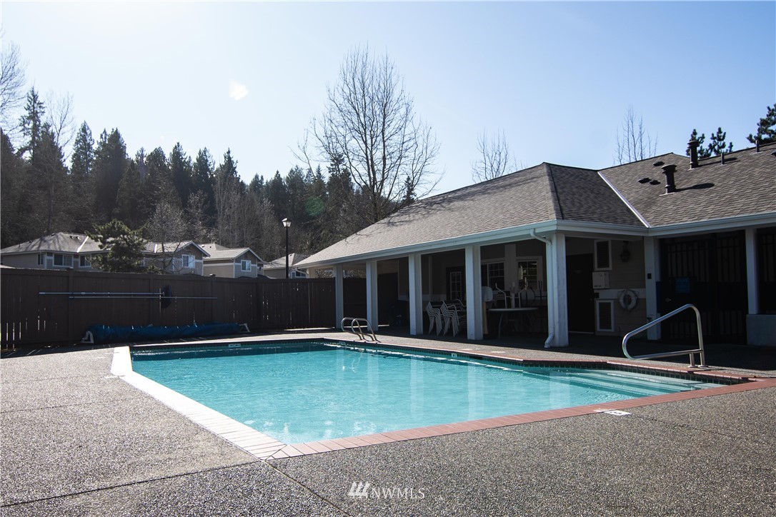 15150 140th Way Southeast, Unit G104 Renton, WA 98058 - Photo 23 of 24 a view of a house with swimming pool and sitting area
