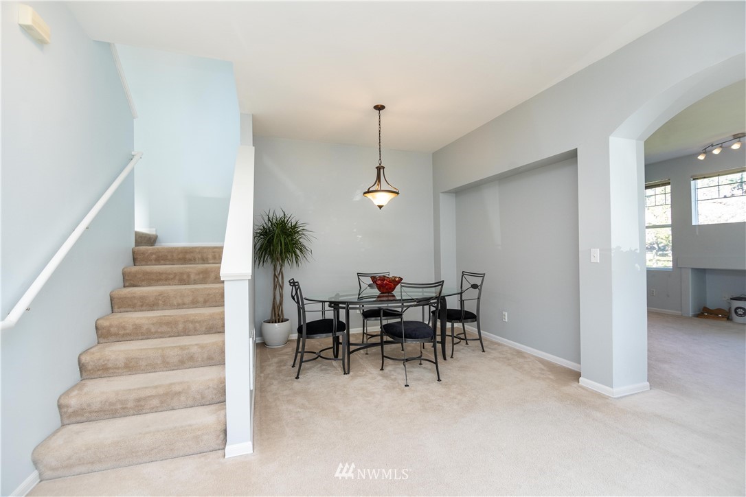 15150 140th Way Southeast, Unit G104 Renton, WA 98058 - Photo 5 of 24 a dining room with furniture and white walls