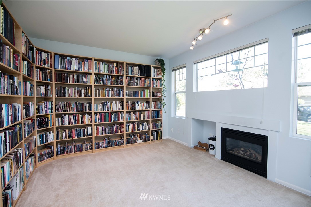 15150 140th Way Southeast, Unit G104 Renton, WA 98058 - Photo 6 of 24 a view of an empty room with furniture and a fireplace