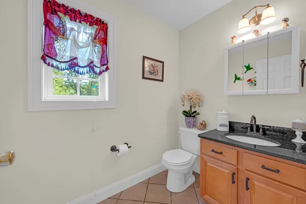 a bedroom with a bed next to a window with a flat screen tv