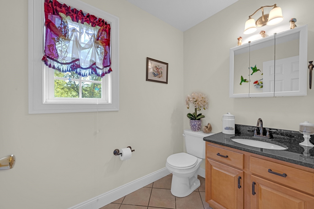12 Malboeuf Road Ware, MA 01082 - Photo 13 of 42 a bathroom with a granite countertop sink mirror vanity and toilet