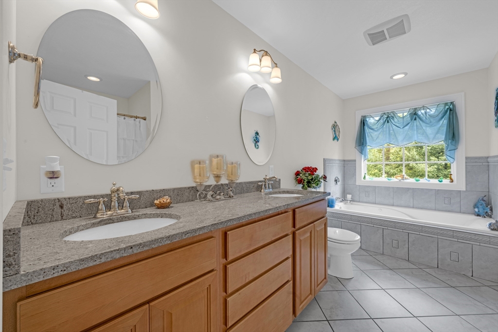 12 Malboeuf Road Ware, MA 01082 - Photo 17 of 42 a bathroom with a granite countertop toilet sink and mirror