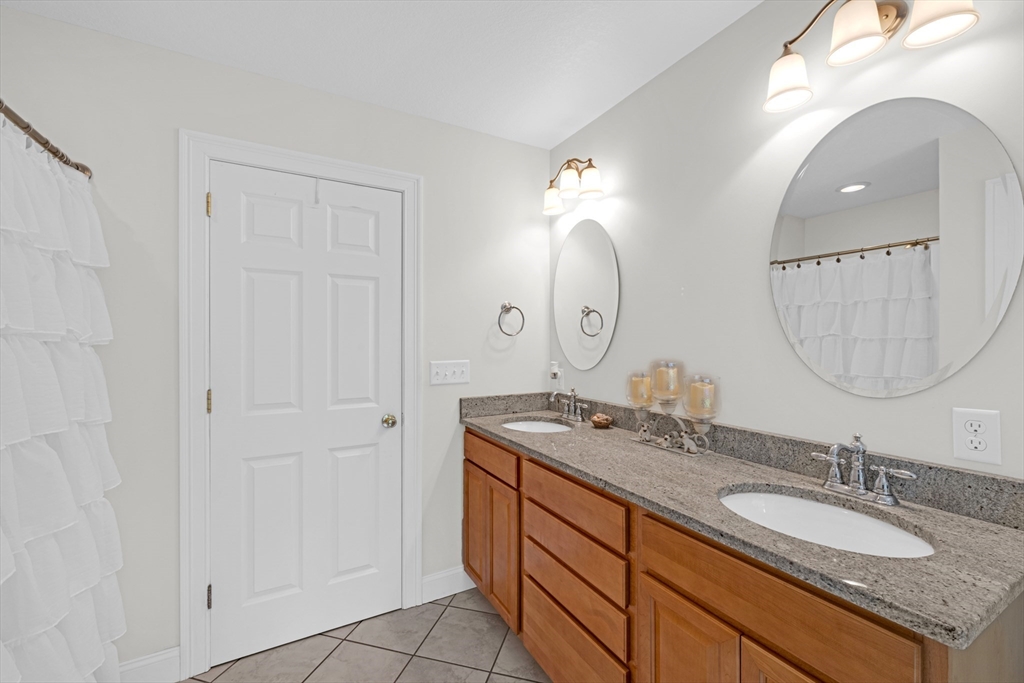 12 Malboeuf Road Ware, MA 01082 - Photo 18 of 42 a bathroom with a granite countertop double vanity sink and a mirror