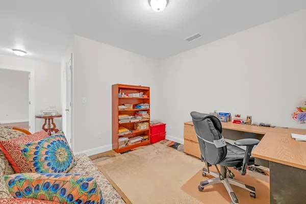 a bathroom with a granite countertop sink a toilet and a mirror