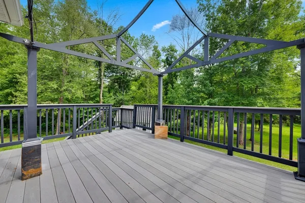 a view of a house with a wooden deck