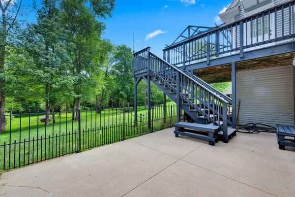 a view of a house with a yard and lawn chairs