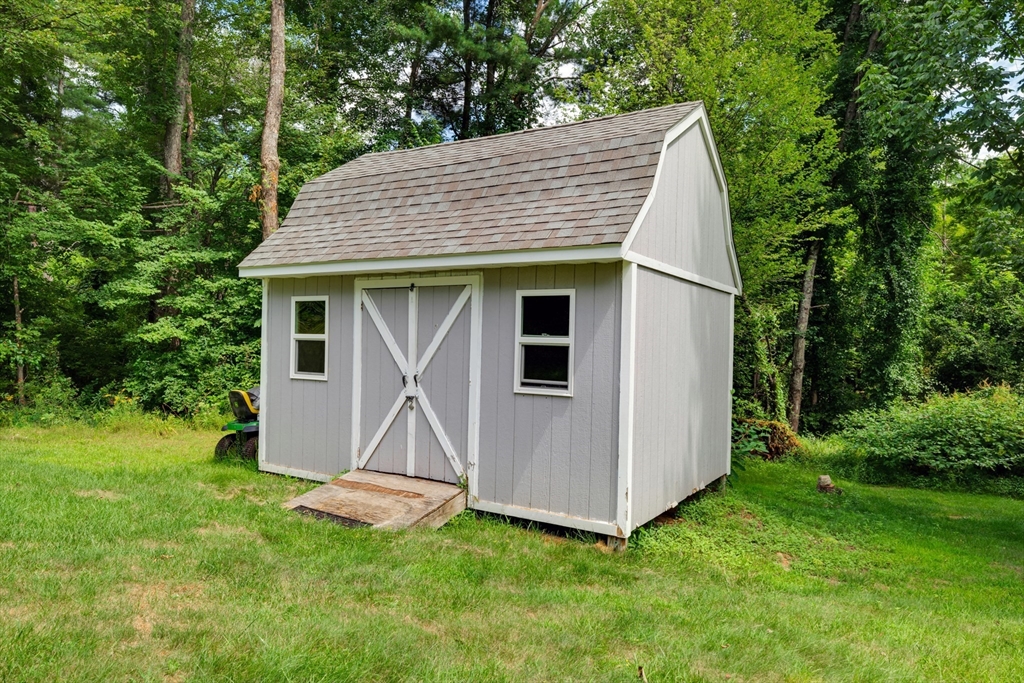 12 Malboeuf Road Ware, MA 01082 - Photo 33 of 42 a view of a house with a yard and lawn chairs
