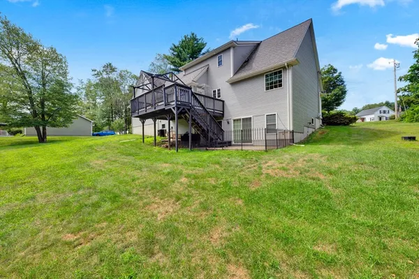 a aerial view of a house with a yard table and chairs