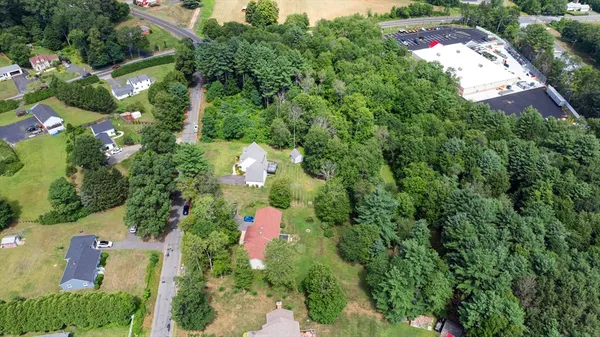 an aerial view of a house with a yard and garden