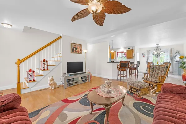 a kitchen with a dining table chairs and white appliances