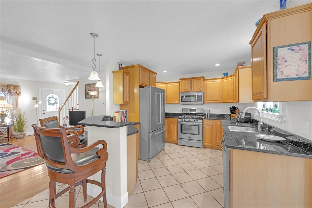 12 Malboeuf Road Ware, MA 01082 - Photo 9 of 42 a kitchen with stainless steel appliances granite countertop a kitchen island a stove a sink a dining table and chairs