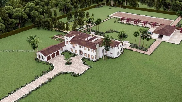 an aerial view of a house with outdoor space swimming pool