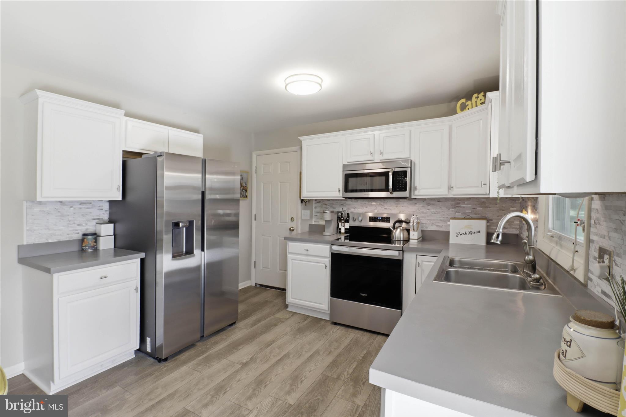 213 Skylark Road Lititz, PA 17543 - Photo 11 of 54 a kitchen with granite countertop a refrigerator stove and sink