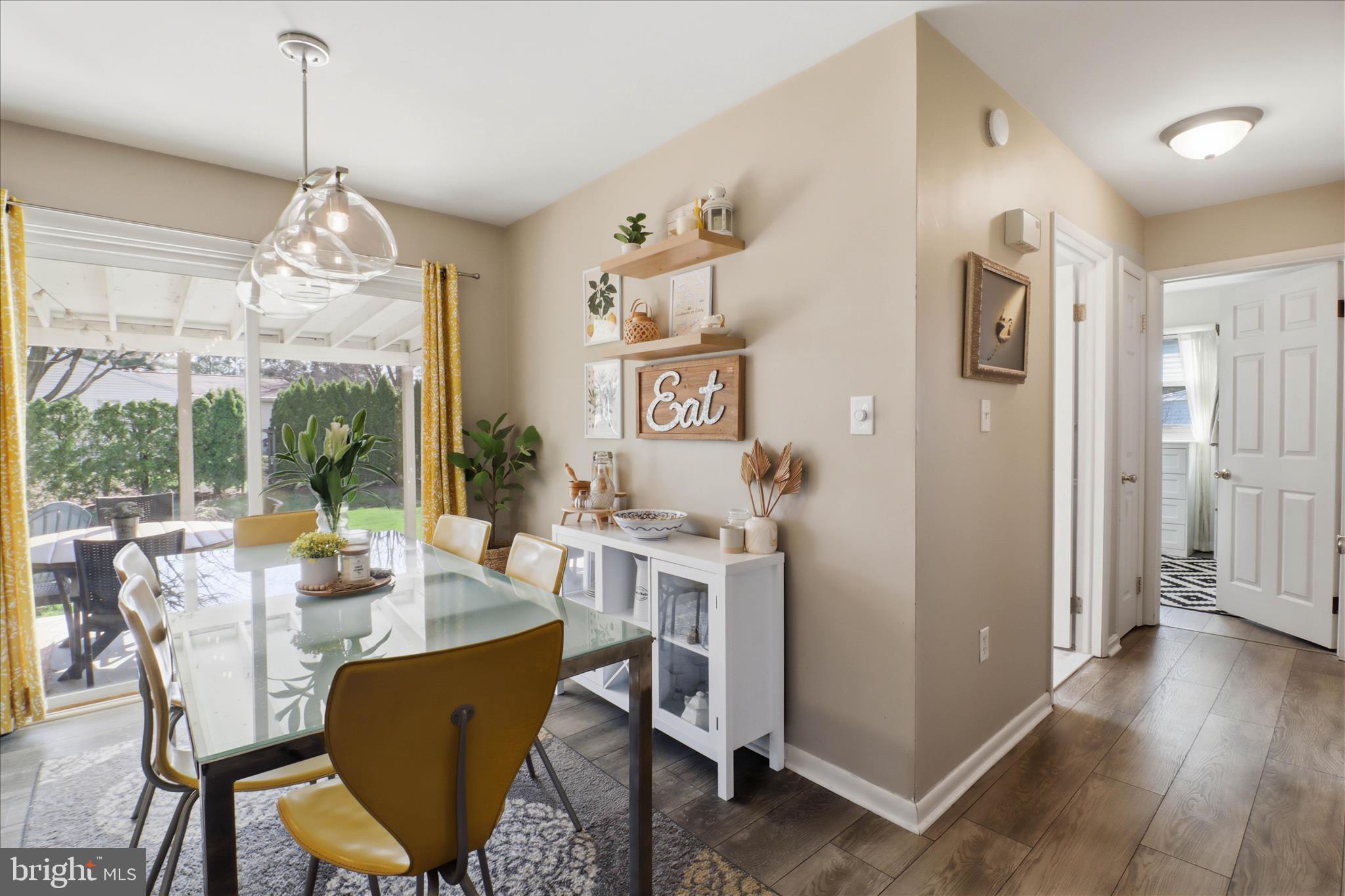 213 Skylark Road Lititz, PA 17543 - Photo 13 of 54 a dining room with wooden floor a chandelier a wooden table and chairs