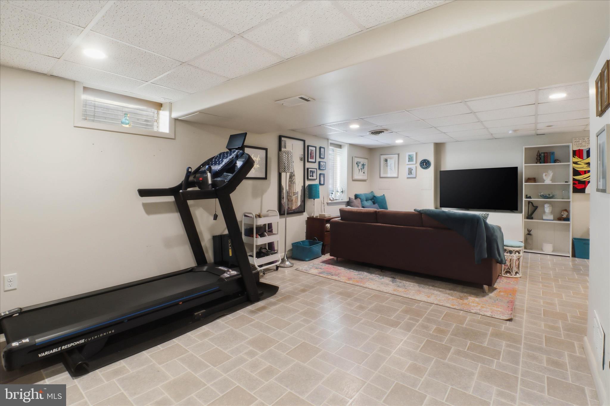 213 Skylark Road Lititz, PA 17543 - Photo 34 of 54 a living room with furniture gym equipment and a flat screen tv