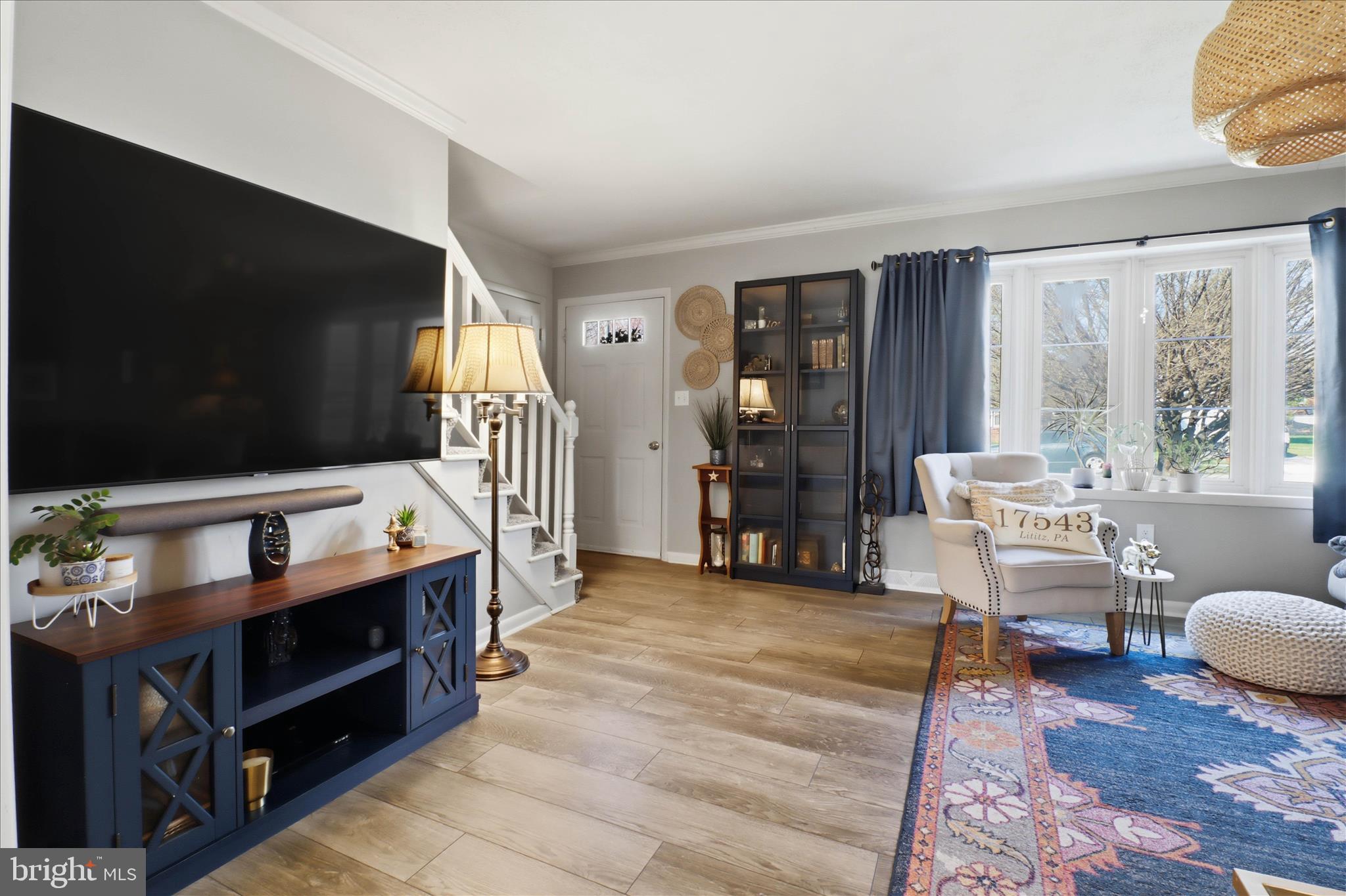 213 Skylark Road Lititz, PA 17543 - Photo 5 of 54 a living room with furniture a flat screen tv and a refrigerator