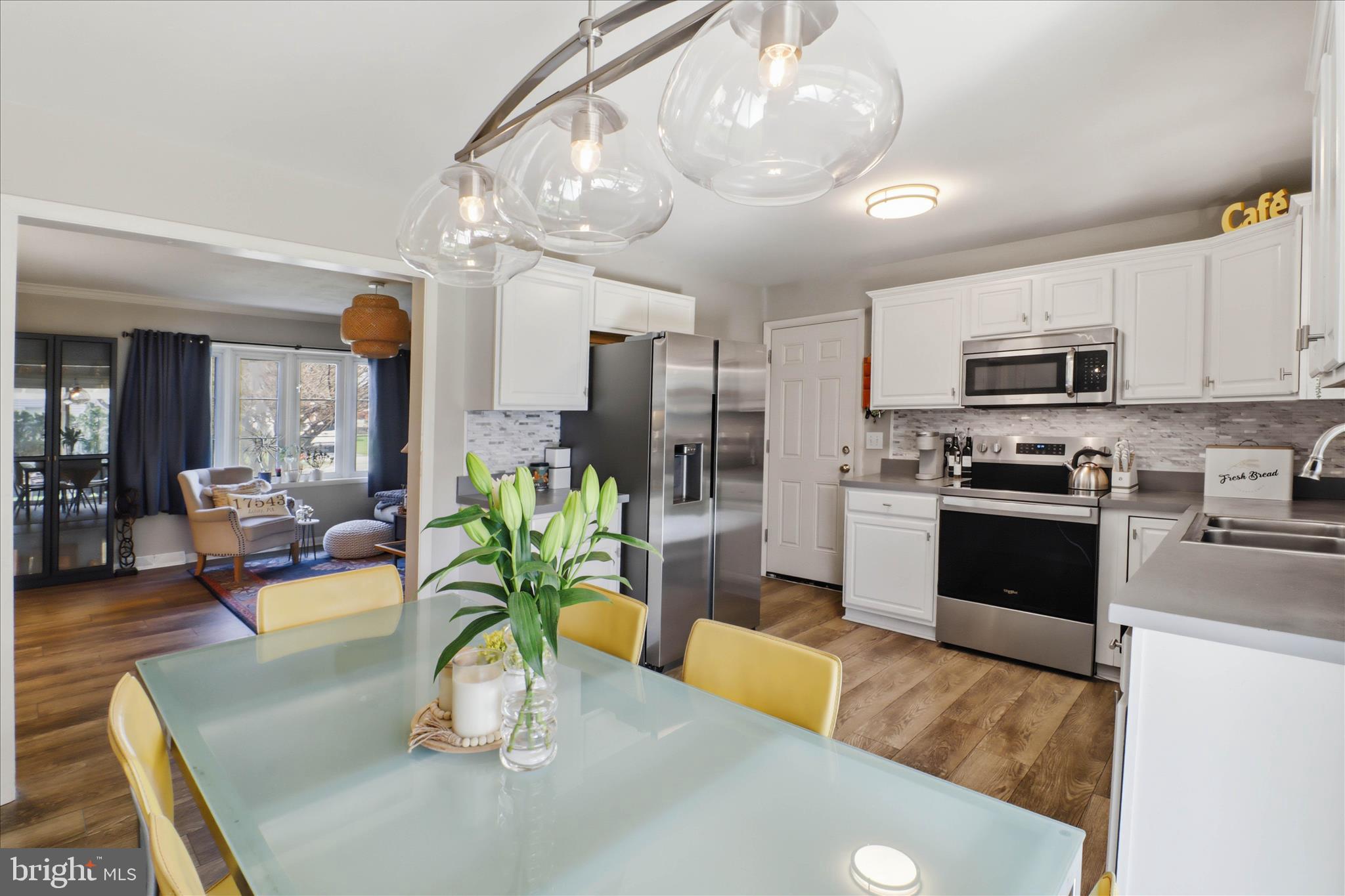 213 Skylark Road Lititz, PA 17543 - Photo 10 of 54 a kitchen with stainless steel appliances granite countertop a refrigerator a stove top oven a sink a dining table and chairs