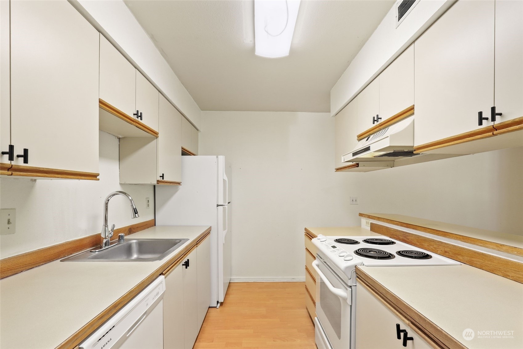 1830 South 336th Street, Unit C201 Federal Way, WA 98003 - Photo 12 of 30 a kitchen that has a sink and a stove