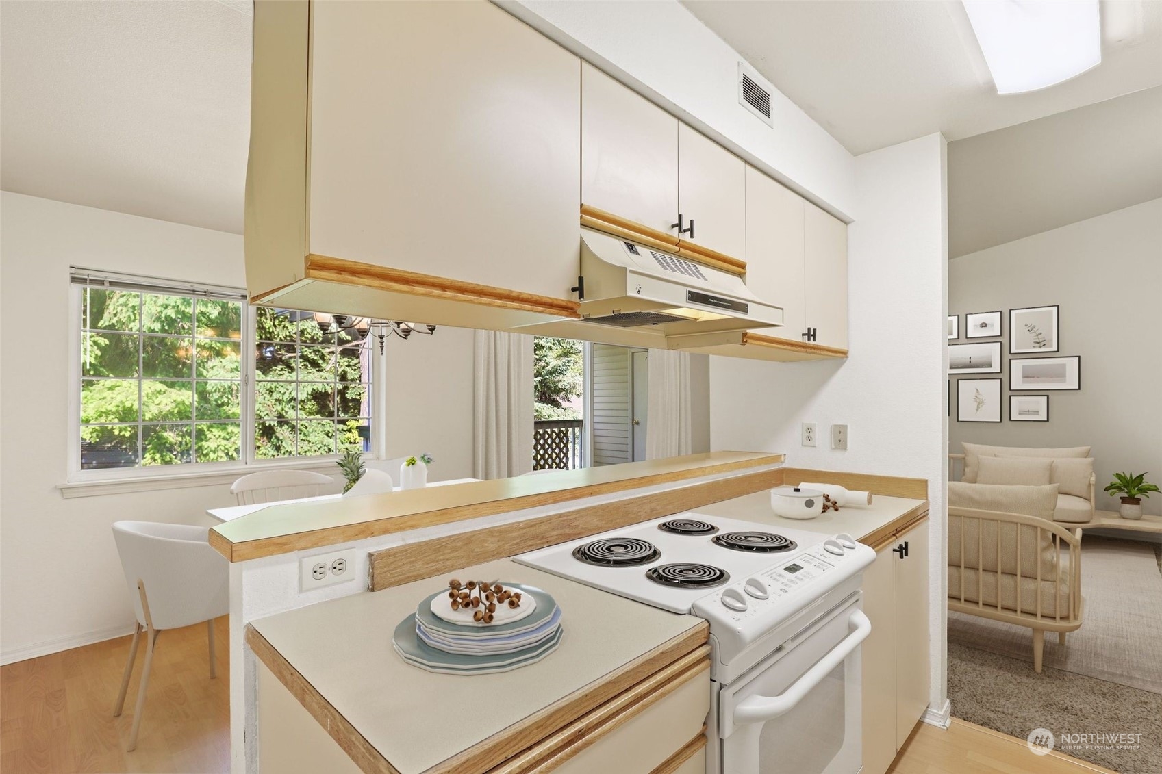 1830 South 336th Street, Unit C201 Federal Way, WA 98003 - Photo 13 of 30 a kitchen with a stove a sink and a refrigerator