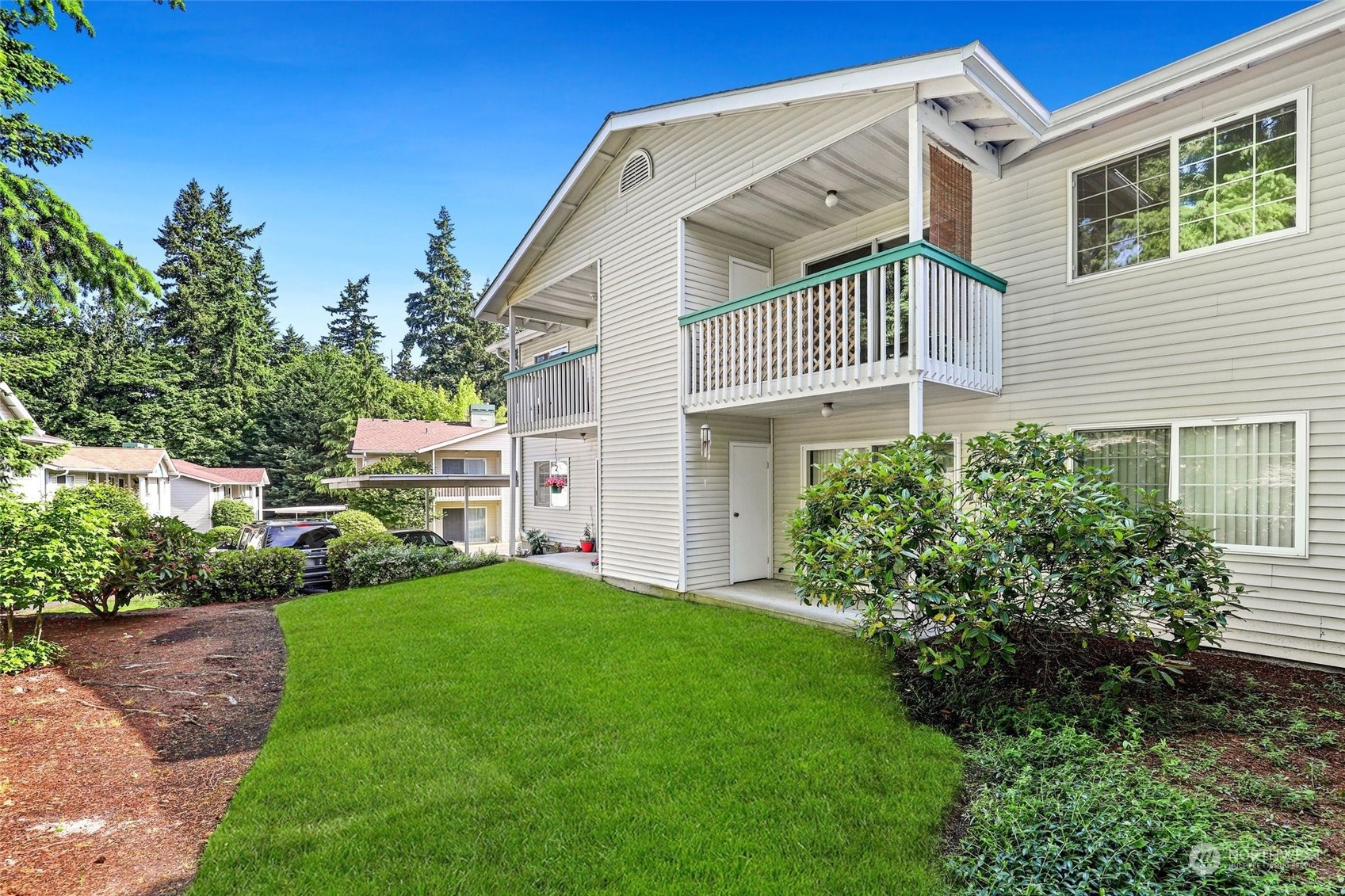 1830 South 336th Street, Unit C201 Federal Way, WA 98003 - Photo 22 of 30 a front view of a house with a yard