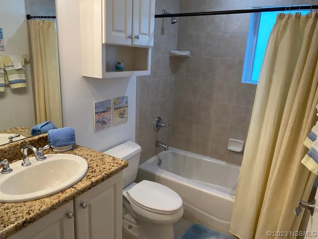 a kitchen with kitchen island granite countertop a sink stove and refrigerator