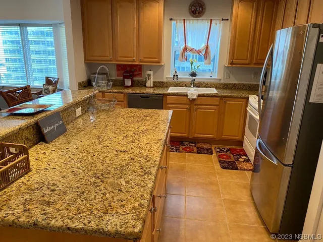 a living room with furniture a large window and wooden floor