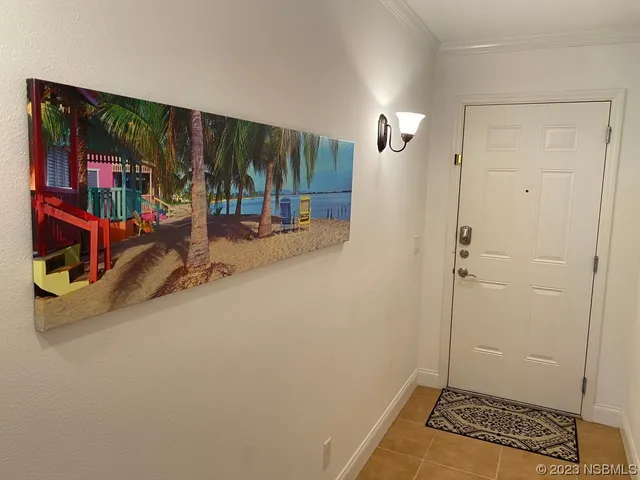 a view of a bedroom with a bed and wooden floor