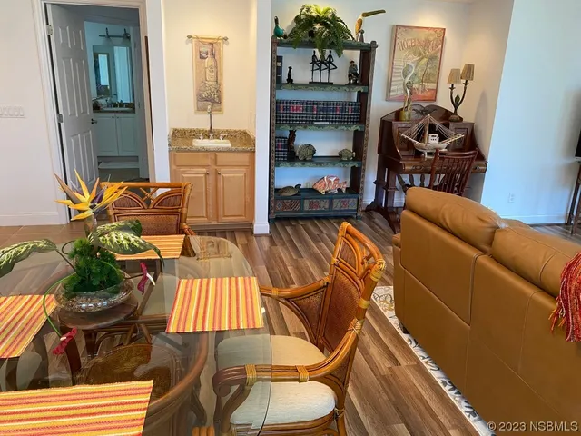 a view of a hallway with wooden floor windows and a livingroom