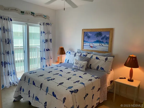 a bedroom with a bed and painting on the wall