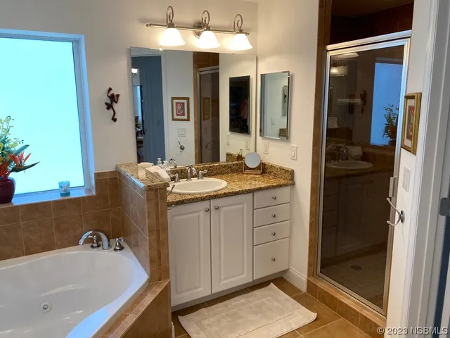 a bath tub sitting next to a bathroom sink