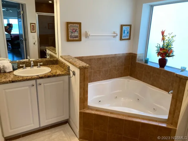 a bathroom with a granite countertop sink a toilet and a mirror