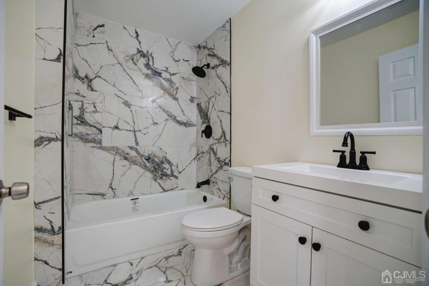 124 Edpas Road New Brunswick, NJ 08901 - Photo 19 of 24 a bathroom with a sink a toilet and shower