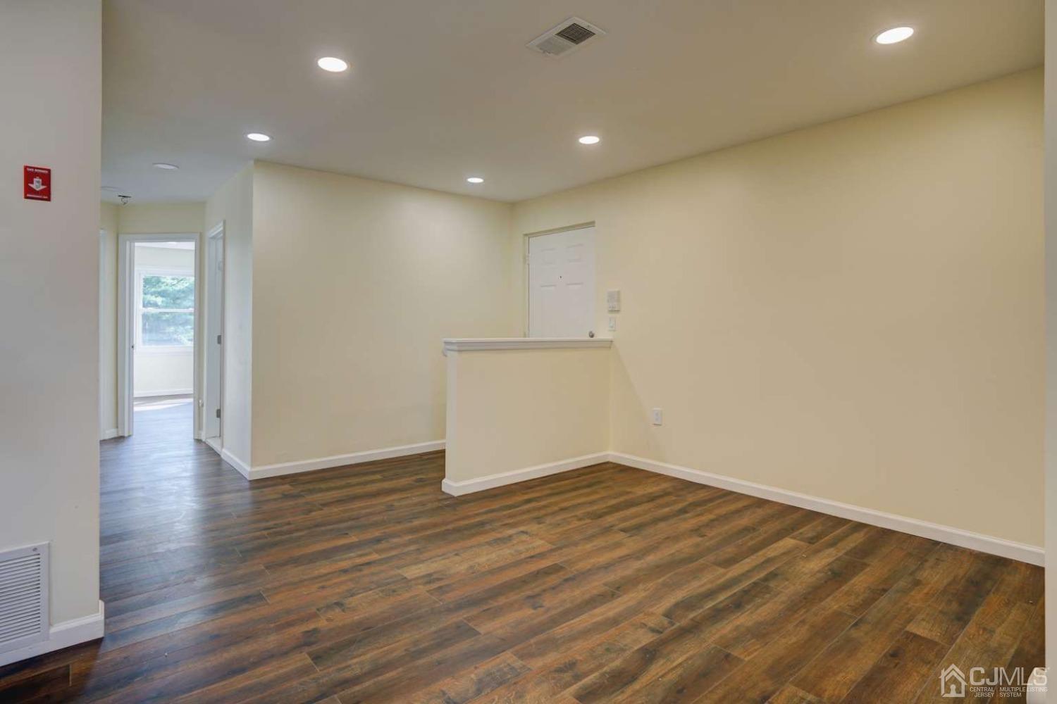 124 Edpas Road New Brunswick, NJ 08901 - Photo 6 of 24 a view of an empty room with wooden floor