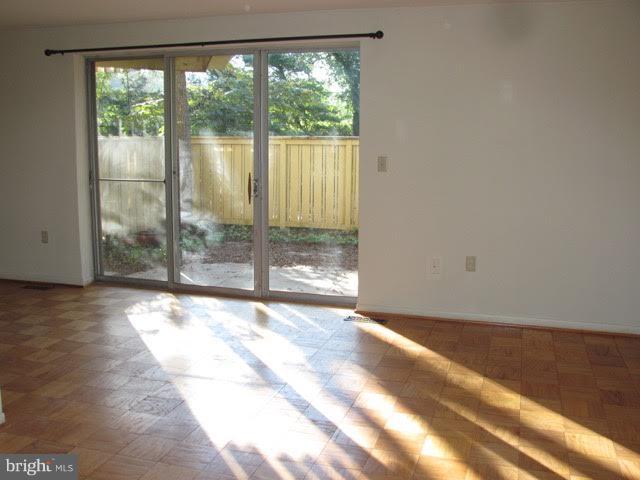 7 Hamill Road, Unit 7B Baltimore, MD 21210 - Photo 3 of 14 a view of a room with wooden floor and doors