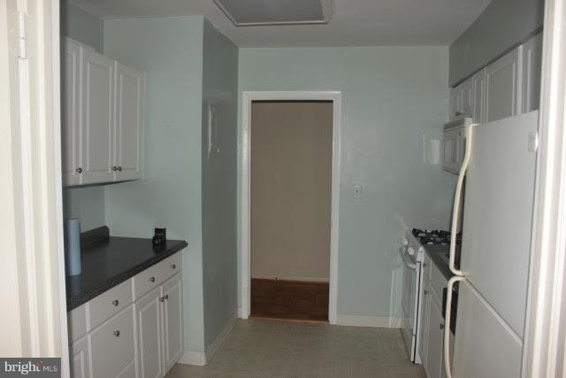 7 Hamill Road, Unit 7B Baltimore, MD 21210 - Photo 7 of 14 a kitchen with a refrigerator and cabinets