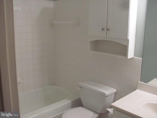 7 Hamill Road, Unit 7B Baltimore, MD 21210 - Photo 8 of 14 a white toilet sitting next to a bath tub
