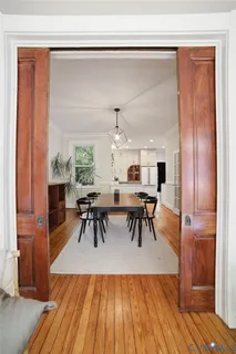 a view of a dining room with furniture and wooden floor