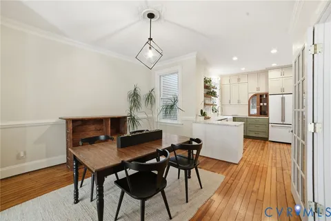 a view of a dining room with furniture window and wooden floor